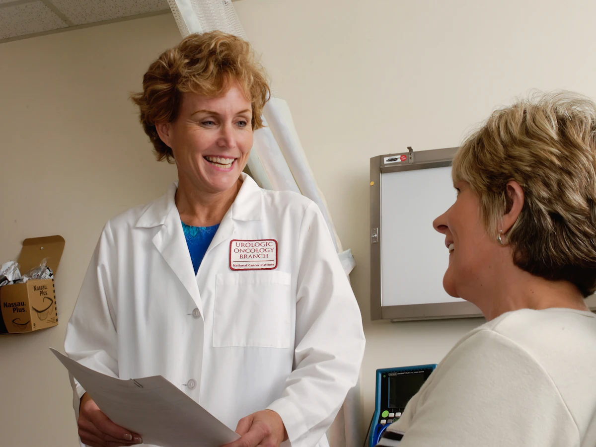 Illustrative photograph of a clinician discussing care with a woman